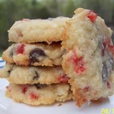 a stack of cookies sitting on top of a white plate next to a blue and white striped napkin