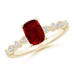 a gold ring with a red stone and white diamonds