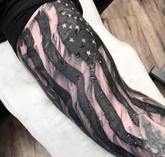 an american flag tattoo on the right arm and left arm, with stars all over it