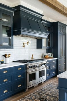 a kitchen with blue cabinets and an oven