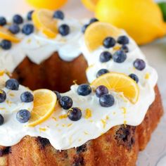 a cake with lemons and blueberries on it