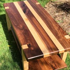 a wooden bench sitting in the grass