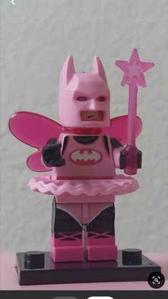 the pink batgirl is holding a star on her hand and wearing a costume that has been made out of legos