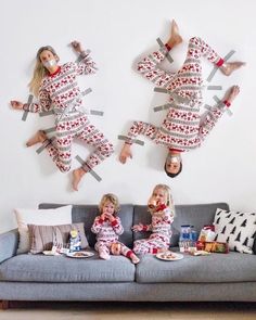 two women in matching pajamas sitting on a couch with their legs spread out as they eat