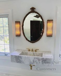 a bathroom sink sitting under a mirror next to a window