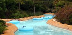 a water park with several blue inflatables floating down it's side