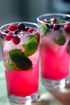 two glasses filled with ice and cranberries