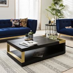 a living room with two couches, a coffee table and a rug on the floor