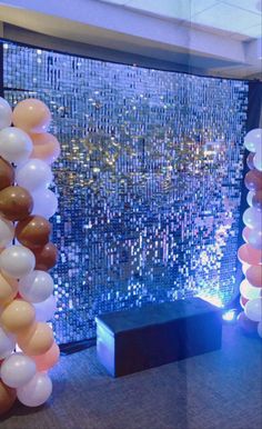 balloons and streamers are on display in front of a large window with city lights