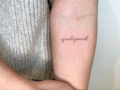 a person with a small tattoo on their arm that says,'trapped'in cursive writing