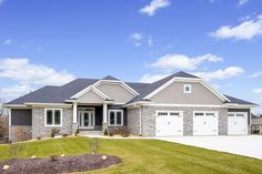 a large house with two garages on the front