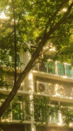 an apartment building is seen through the trees