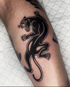 a man with a tattoo on his arm that has a black and white tiger on it