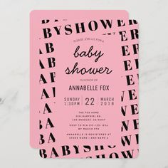 a pink and black baby shower card on a white marble surface with the words, baby shower in cursive font