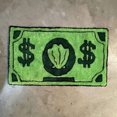 a green rug with dollar signs on it