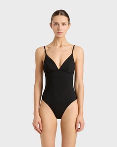 The Emilia One Piece in Black is a classic and elegant swimsuit featuring a triangle bra, adjustable rouleau straps, under-bust support and a medium to high leg line with regular bottom coverage. Emilia is made from our unique Singuleur® fabric that moves with the body like a second skin. Luxury fabric sustainably made in Italy. Garment ethically and sustainably made in Australia. Elegant Swimsuit, Classic Swimsuit, Matching Separates, Luxury Fabric, Triangle Bra, Halter Maxi Dresses, Designer Swimwear, Organic Linens, Dress Cover