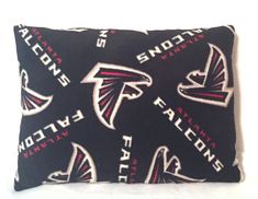 a black pillow with atlanta falcons on it