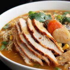 a white bowl filled with meat and vegetables