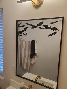 a bathroom mirror with bats on it