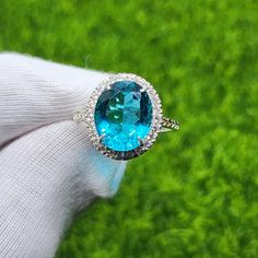 Item Details:  Gemstone: Lab Created Paraiba Tourmaline  Main stone  Size: 10x12MM Base Material: 925 Sterling Silver Plating: Silver, Gold, Rose Gold Platted Our processing time is  up-to 7 working days  and our standard shipping run up-to 15 to 18 days. If you want express shipping please message us  on Etsy. Order Cancellation : We accept order cancellation within 24 hours of placing order, Otherwise We don't cancel the order. Return/Exchange: Return or Exchange accepted within 14 days of del Formal Oval Topaz Ring With Halo Setting, Formal Oval Crystal Ring With Accent Stones, Formal Oval Emerald Ring With Gemstone Accents, Oval Blue Topaz Diamond Ring, Oval Emerald Ring With Gemstone Accents, Oval Topaz Ring With Halo Setting, Formal Oval Topaz Ring With Gemstone Accents, Formal Oval Crystal Gemstone Ring, Formal Oval Crystal Ring