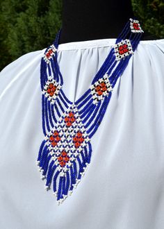 The necklace consists of several strings of blue beads, which are fastened together with white inserts of beads forming a fancy pattern      Length 22 inches (56 cm).  Pendant: heigh 4.5 inches (12 cm), width 2.5 inches (6 cm). Lobster claw clasp. This necklace transforms the look, adding a touch of flavor, color and elegance.      Holiday is coming! Now is the right time to buy a gift for your parents, sisters, children, relatives, friends, acquaintances, your loved ones and for yourself! Festival Blue Beaded Necklaces With Colorful Beads, Handmade Blue Beaded Necklaces For Festivals, Blue Beaded Necklaces For Festivals, Traditional Blue Beaded Necklaces With Colorful Beads, Traditional Blue Beaded Necklaces, Traditional Blue Beaded Necklace For Gift, Blue Polished Beaded Necklaces For Festivals, Traditional Blue Beaded Jewelry, Blue Polished Beaded Necklace For Festivals