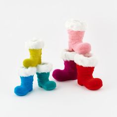 three pairs of colorful socks sitting next to each other on top of a white surface