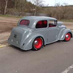 an old car is parked on the side of the road