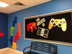 an office with blue walls and colorful video game controllers hanging on it's wall