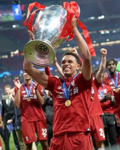 the liverpool united players celebrate with the trophy