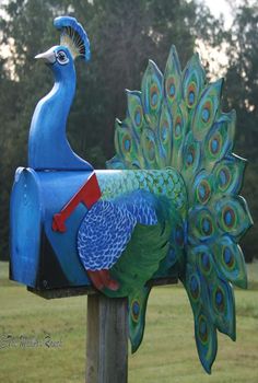 a blue mailbox with a peacock painted on it