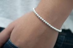 You are sure to fall in love with classic sterling silver bead bracelet. This is a simple single strand bracelet strung with  seamless sterling silver balls. All components including the clasp are sterling silver. It is strong using a flexible bead wire to ensure it will last for a very long time. It will arrive in a pretty organza bag. The beads have a diameter of 4mm.This silver bracelet is a treasure! It would make a lovely gift! Silver Beaded Bracelets, Bead Bra, Sweet Jewelry, Bracelets Silver, Sterling Silver Bead Bracelet, Bracelet Bead, Sterling Bracelets, Silver Bead Bracelet, Pretty Bracelets