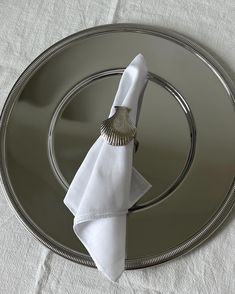 a silver plate topped with a white napkin