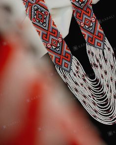 the necktie is decorated with beads and bead work on it's collar