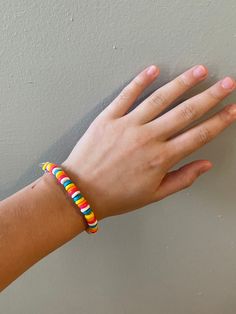 Multicolored bead bracelets on stretchy clear string.  Lobster claw closure. Rainbow Adjustable Stretch Bracelet, Adjustable Rainbow Stretch Bracelet, Multicolor Plastic Beaded Jewelry, Colorful Plastic Beads Jewelry, Colorful Adjustable Plastic Beaded Bracelets, Trendy Multicolor Stretch Bracelet With Round Beads, Multicolor Plastic Jewelry For Friendship, Adjustable Rainbow Stretch Bracelet Hand-strung, Adjustable Multicolor Beaded Plastic Bracelets