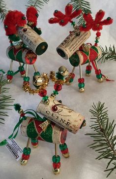 three wine corks with bells and decorations on them