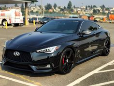 a black sports car parked in a parking lot