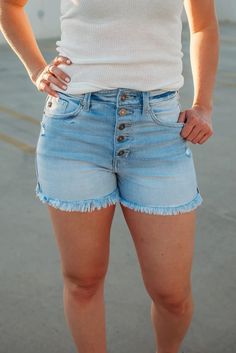 Short season is calling! These adorable denim shorts have the cutest button detailing with frayed edges. These will complete your summer wardrobe!95% Cotton, 4% Polyester, 1% SpandexModel is 5'6", size 25" waist and shown wearing a size mediumInseam: 3" Rise: 10"These run small. We recommend sizing up one size. Chic Skirts, Perfect Denim, Summer Work Outfits, Workout Attire, Classic Jeans, High Rise Shorts, Romper With Skirt, Casual Elegance, Summer Wardrobe