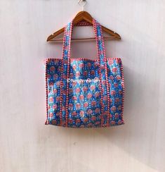 cotton quilted Jhola Bag made by Indian Artisans, this cotton quilted shopping bag is totally unique and multi purpose. Use this for your grocery or as a travel bag. Perfect to suit all. Size in Inch:- Height-19" inch Width- 25" inch Handle-11" inch Size In CM:- 40x40x13 cm Handle height- 35 cm Material: 100% Cotton Pattern: Quilted Style: Ethnic Product Work: Printed & quilted Stitched Usage : Cosmetic, Make-up, Travel, Toiletries, Medicine, Accessories, Shopping and much more. Perfect for Beach Visits/ Quick Grocery runs/ Carrying Kids items/ Artist Paint book and Paints /Extra Bag Washable on Cold / Delicate wash Make a good Sustainable Gift . Wash Care Instructions:- Dry clean only. Bohemian Reversible Cotton Bag, Quilted Cotton Shoulder Bag For Daily Use, Quilted Cotton Shoulder Bag In Rectangular Shape, Quilted Cotton Rectangular Shoulder Bag, Rectangular Quilted Cotton Shoulder Bag, Painted Books, Sustainable Gifts, Kids Items, Travel Toiletries