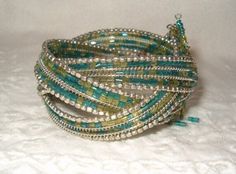 Ethnic Songs!  Turquoise w Yellow Bugle Bead Bracelet, Wire Bangle Bracelet, Silver Beading, 3 Hanging Charm Beads, 1 Missing, very tiny, 1960's. Jewelry, Beaded Bracelets, Bracelets Green Beaded Wrap Bracelet For Festival, Bohemian Green Beads, Turquoise Beaded Wrap Bangle Bracelet, Green Bohemian Beaded Bracelets With Silver Beads, Bugle Bead Bracelet, Wire Bangle Bracelets, Wire Bangles, Charm Beads, Jewelry Beaded