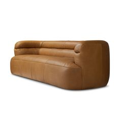 a brown leather couch sitting on top of a white floor