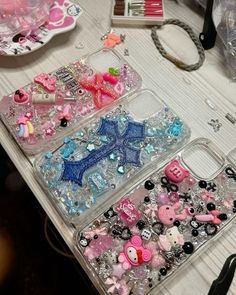 two clear cases filled with lots of different types of beads and charms on top of a table