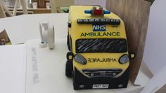 a cake made to look like an ambulance is sitting on top of a white table