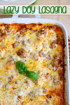 a casserole dish with cheese and spinach on top, sitting on a table