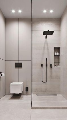 a bathroom with a walk in shower next to a white toilet and wall mounted urinal