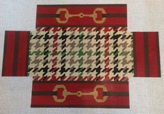 three pieces of red, green and white fabric with gold chains on them are shown