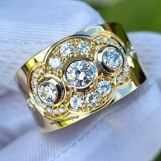 a gold ring with three diamonds on it