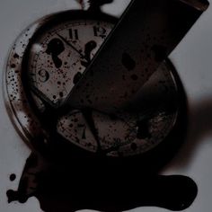 an old pocket watch with the time being 11 30 on it's face and dripping paint