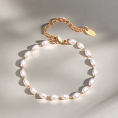 Elevate your wrist wear with our Elegant Oval Pearl Bracelet, a sophisticated piece that captures the essence of timeless elegance. This bracelet features lustrous oval-shaped pearls strung together with delicate craftsmanship, perfect for adding a touch of classic beauty to any attire. Key Features: - Oval Pearls: Exquisitely selected for their shape and radiance, each pearl brings a touch of sophistication. - Durable Clasp: Secured with a high-quality clasp for easy wear and lasting use. - - Versatile Style: The bracelet's simple yet elegant design complements both casual and formal looks. - Perfect Gift: Beautifully presented, it's an ideal gift for anniversaries, birthdays, or a special treat for yourself. Ordering Process: Select your preferred bracelet size, add to cart, and proceed Feminine Pearl Bracelets With Pearl Charm, Elegant Adjustable Bracelet With Pearl Drop, Minimalist Metal Pearl Bracelet, Classic Metal Beaded Bracelets As Gift, Classic Metal Beaded Bracelets For Gift, Elegant Metal Bracelets With Pearl Drop, Elegant Beaded Bracelets With Pearl Drop, Formal Pearl Charm Chain Bracelet, Feminine Pearl Drop Bracelets