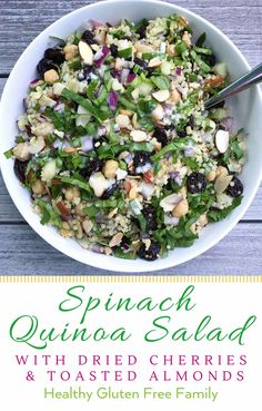 spinach quiche salad with dried cherries and toasted almonds in a white bowl