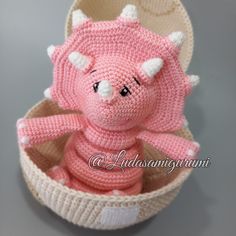 a small knitted pig sitting in a basket